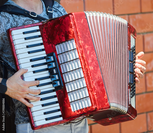 Musical instrument accordion in the hands of a male.