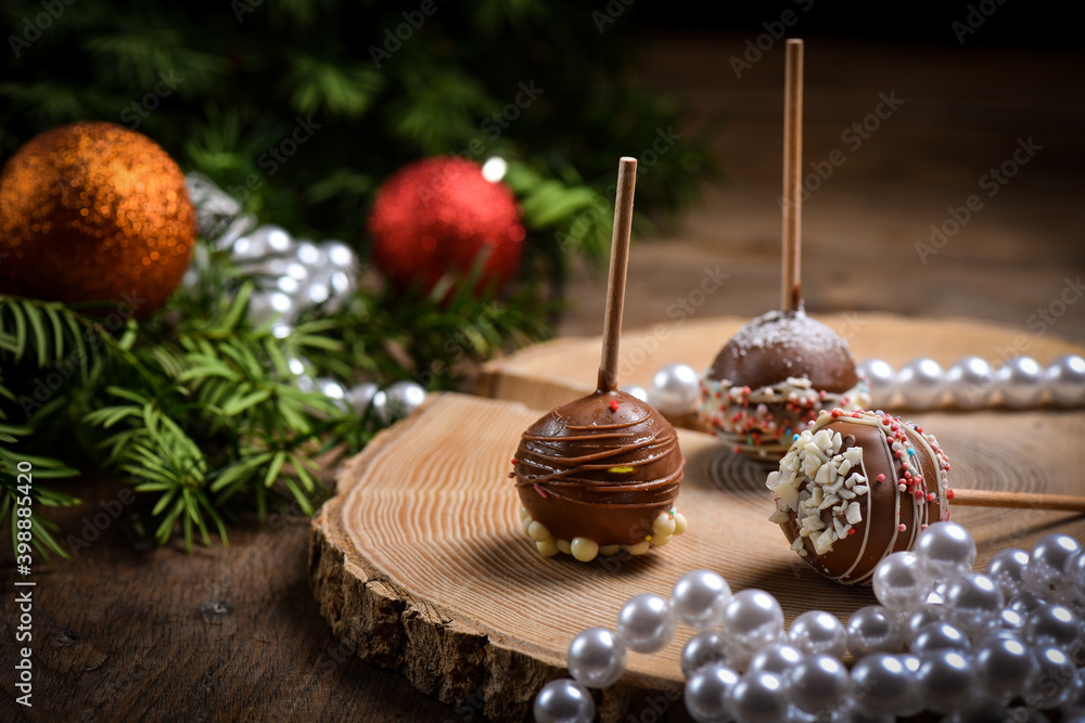 Delicious Christmas themed cake pops on wooden table, closeup Delicious Christmas themed cake pops on wooden table, closeup