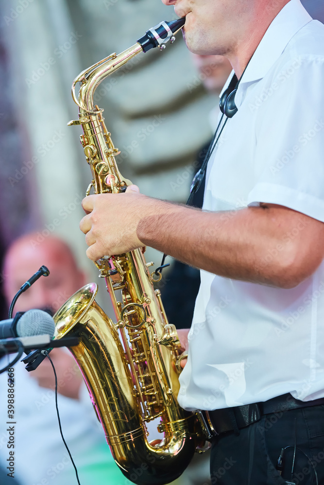 Fototapeta premium Musical instrument saxophone in the hands of the artist.