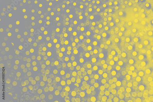 Abstract bokeh background in trendy 2021 new colors. Illuminating Yellow and Ultimate Gray. Color of the Year 2021. Christmas bokeh lights refocused blurred background