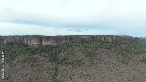 Wallpaper Mural 4k Aerial View Flying Up and Over a Table Rock Butte with Majestic Mountains Torontodigital.ca