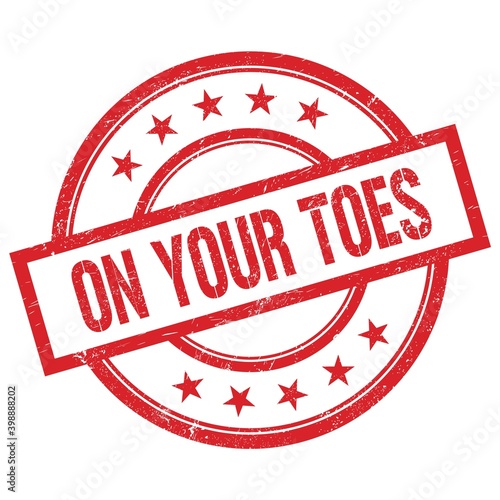 ON YOUR TOES text written on red vintage round stamp.