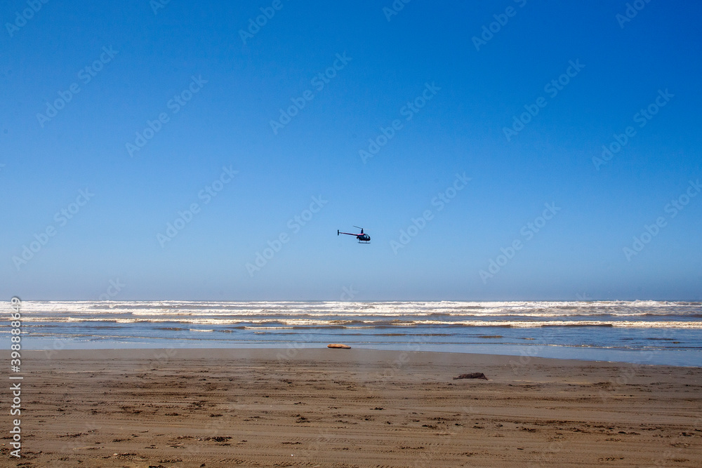 beach waves and small helicopter