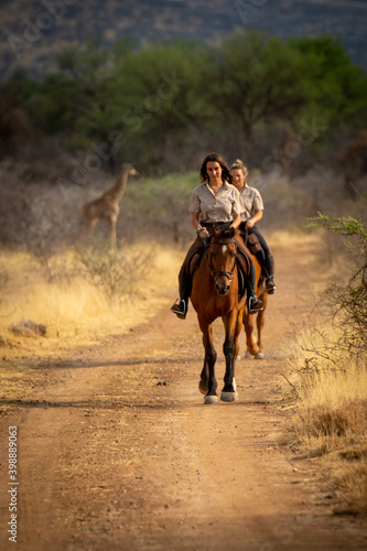 Brunette and blonde ride from southern giraffe © Nick Dale