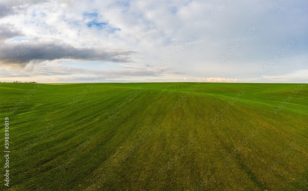 Flying over an green empty field