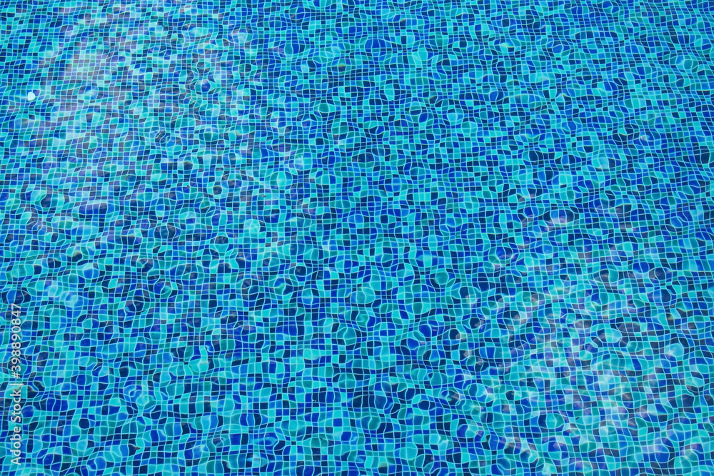 Abstract image of Blue water with ceramic tile mosaic in swimming pool from top view.