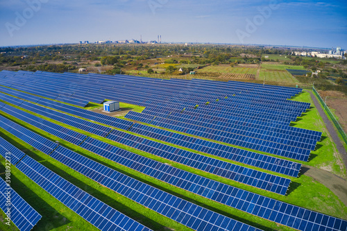 Fly over a renewable solar power plant with sun in Ukraine photo