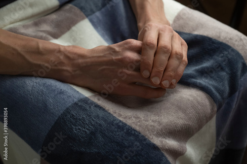 Close-up of the hands of an old sick man.