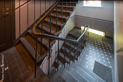 Modern interior of hall in block of flats. Entrance in residential complex. Staircase.