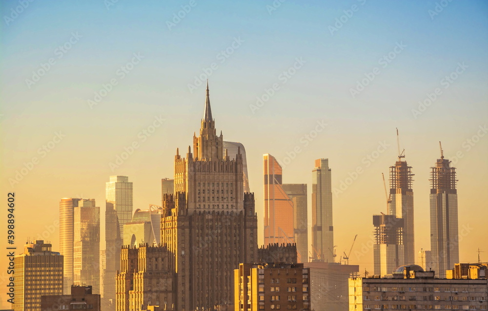 Moscow at sunset. View of the Stalinist skyscraper and the modern architectural complex Moscow City Moscow at sunset. View of the Stalinist skyscraper and the modern architectural complex Moscow City