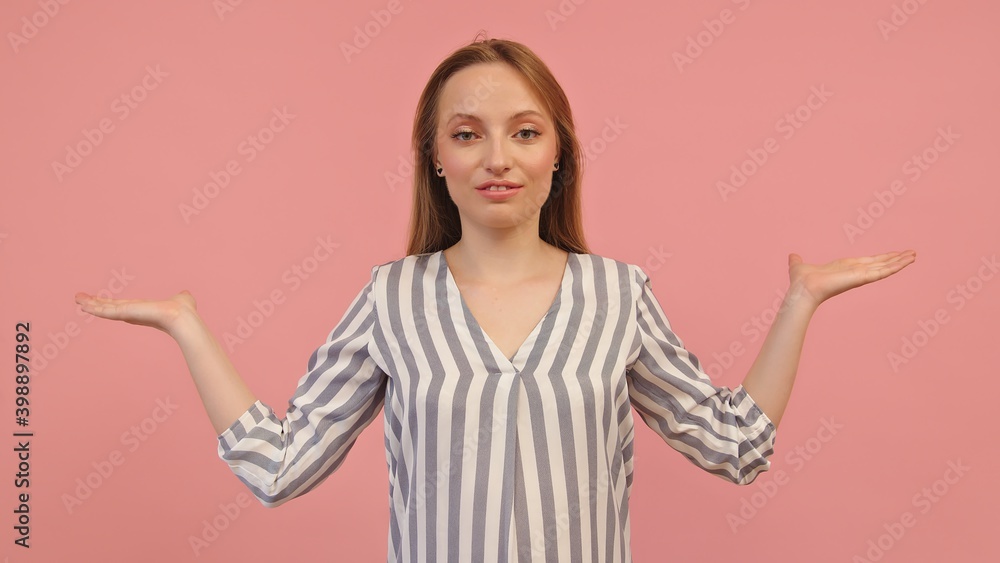 Young caucasian woman with outstretched hands like holding something isolated on pink background. Copy space. High quality photo Young caucasian woman with outstretched hands like holding something isolated on pink background. Copy space. High quality photo