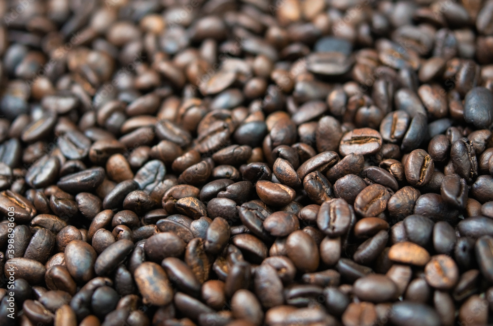 Fototapeta premium Dark roasted coffee beans close-up. Coffee background