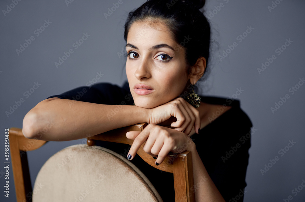 Fototapeta premium elegant lady in black dress makeup model earrings interior