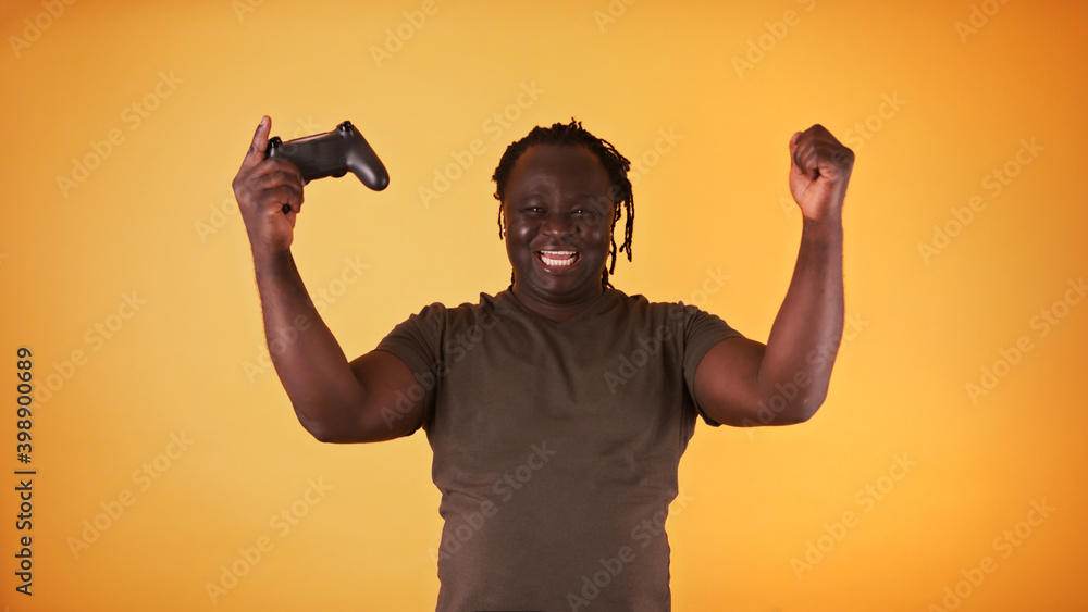 Fototapeta premium African american black man playing video games and winning. Isolated. High quality photo