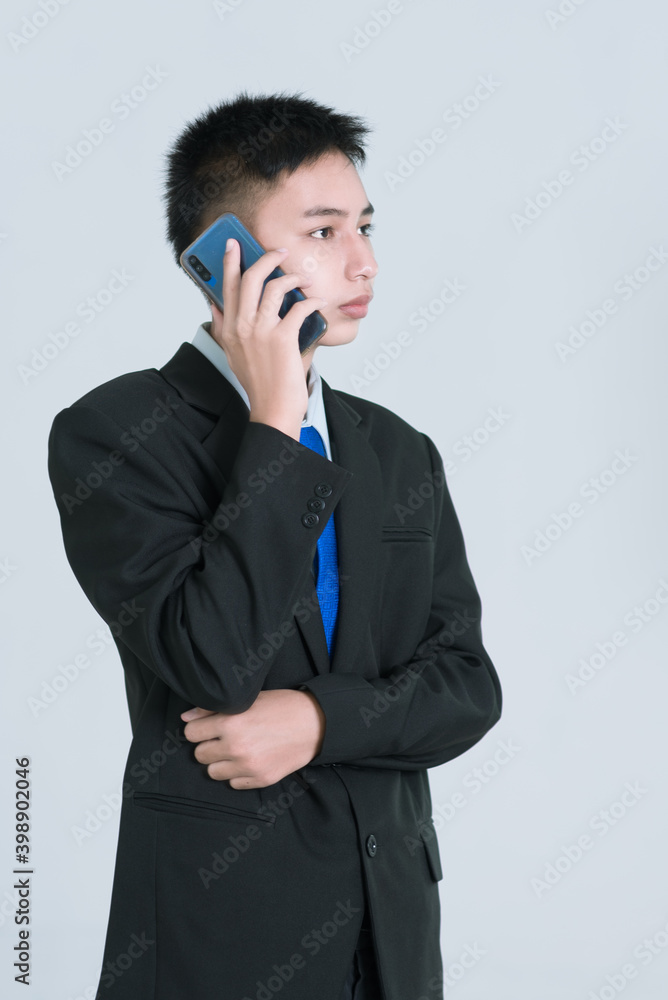 Yong business man or corporate employee isolated on grey background. Classical formal wear office style. Yong business man or corporate employee isolated on grey background. Classical formal wear office style.