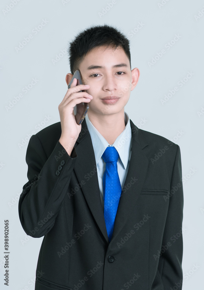 Yong business man or corporate employee isolated on grey background. Classical formal wear office style. Yong business man or corporate employee isolated on grey background. Classical formal wear office style.