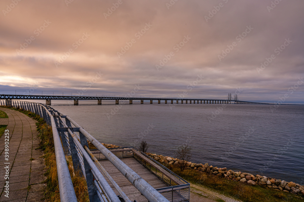 The Sound Bridge, the bridge and underwater tunnel connecting Malmo, Sweden with Copenhagen, Denmark. Beautiful sunset sky in the background