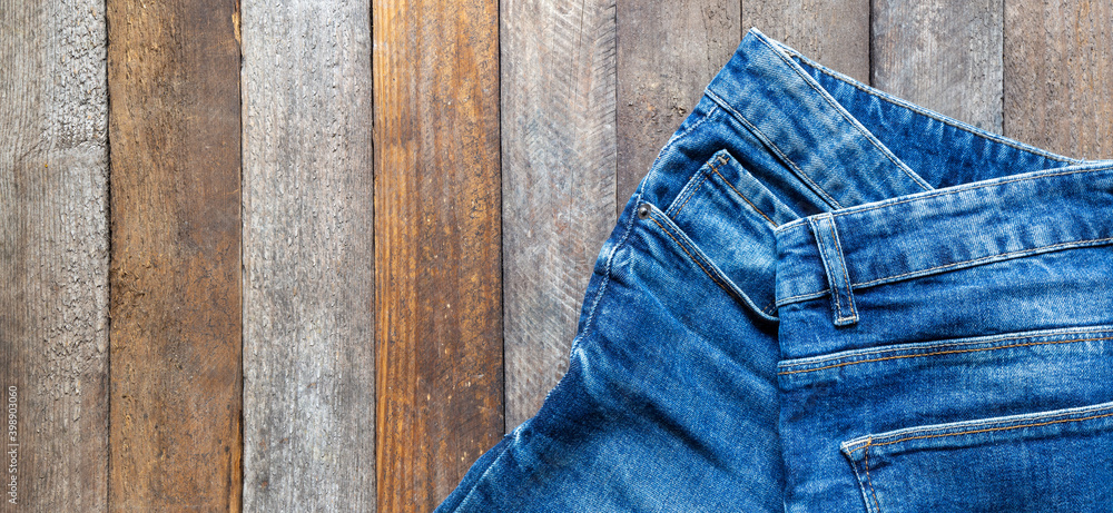 blue jeans on wooden surface background blue jeans on wooden surface background