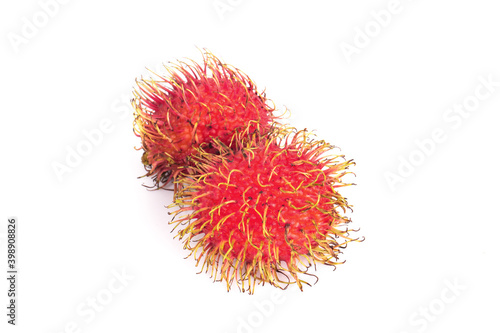 ripe Rambutan fruit in a wooden box isolated on a white background