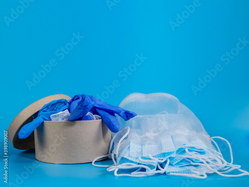 Covid-19. Medical disposable mask and gloves in a gift box, on a blue background. Gift set.