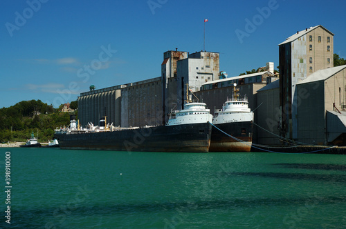 Two tankers docked by a grain elevator in Goderich photo