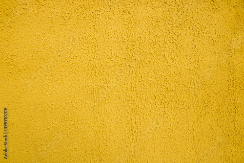 Textured yellow background. Decorative plaster walls, exterior facade decoration