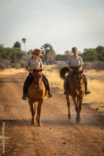 Blonde and brunette ride on dirt track © Nick Dale