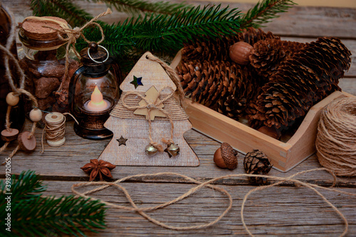 Christmas  card, Christmas 
tree wooden toys, pine branches, pine bumps, candle, rope  on wooden background .
