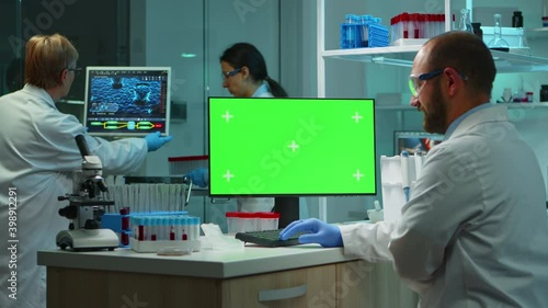 Wallpaper Mural Man researcher looking at chroma key computer in modern equipped lab working overtime. Team of microbiologists doing vaccine research writing on device with green screen, isolated, mockup display. Torontodigital.ca