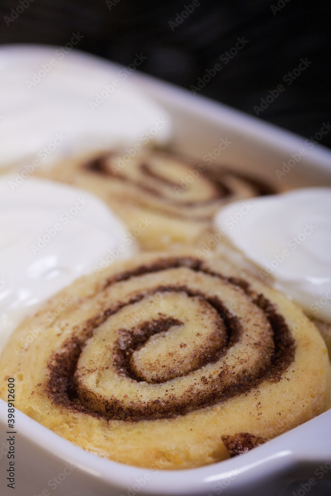 Baking cinnabons. The cinnamon rolls is in the baking dish. Close-up shot. Baking cinnabons. The cinnamon rolls is in the baking dish. Close-up shot.