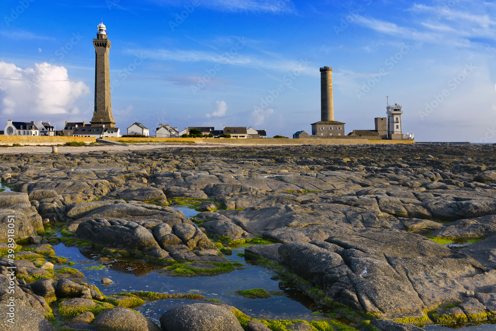 Obraz premium Lighthouse of Eckmuhl and old lighthouse at low tide of Penmarch, a commune in the Finistère department of Brittany in north-western France
