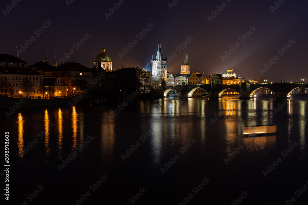 Scenic view of illuminated Prague skyline at night. Charles bridge, Klementinum and National Theater and reflections in Vltava river