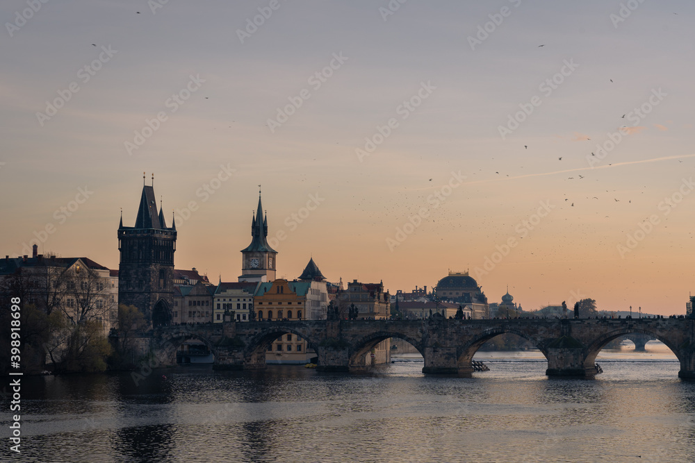 Scenic view of Charles bridge over river Vltava, in Prague. Building of the National Theater in background