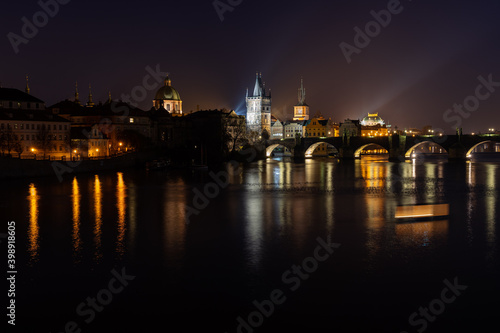Scenic view of illuminated Prague skyline at night. Charles bridge  Klementinum and National Theater and reflections in Vltava river