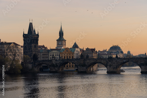 Scenic view of Charles bridge over river Vltava, in Prague. Building of the National Theater in background