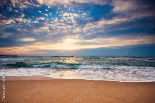 Fototapeta Naklejka Na Ścianę i Meble -  Beach sunrise over the sea and dramatic clouds