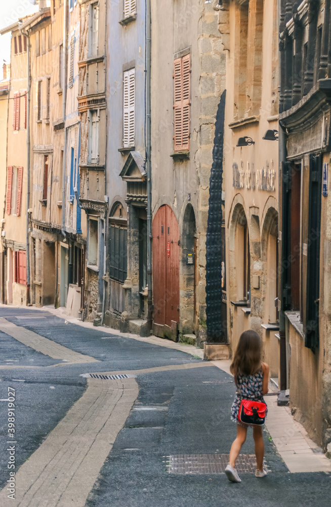 petite fille se promenant dans une rue de la ville de thiers en France