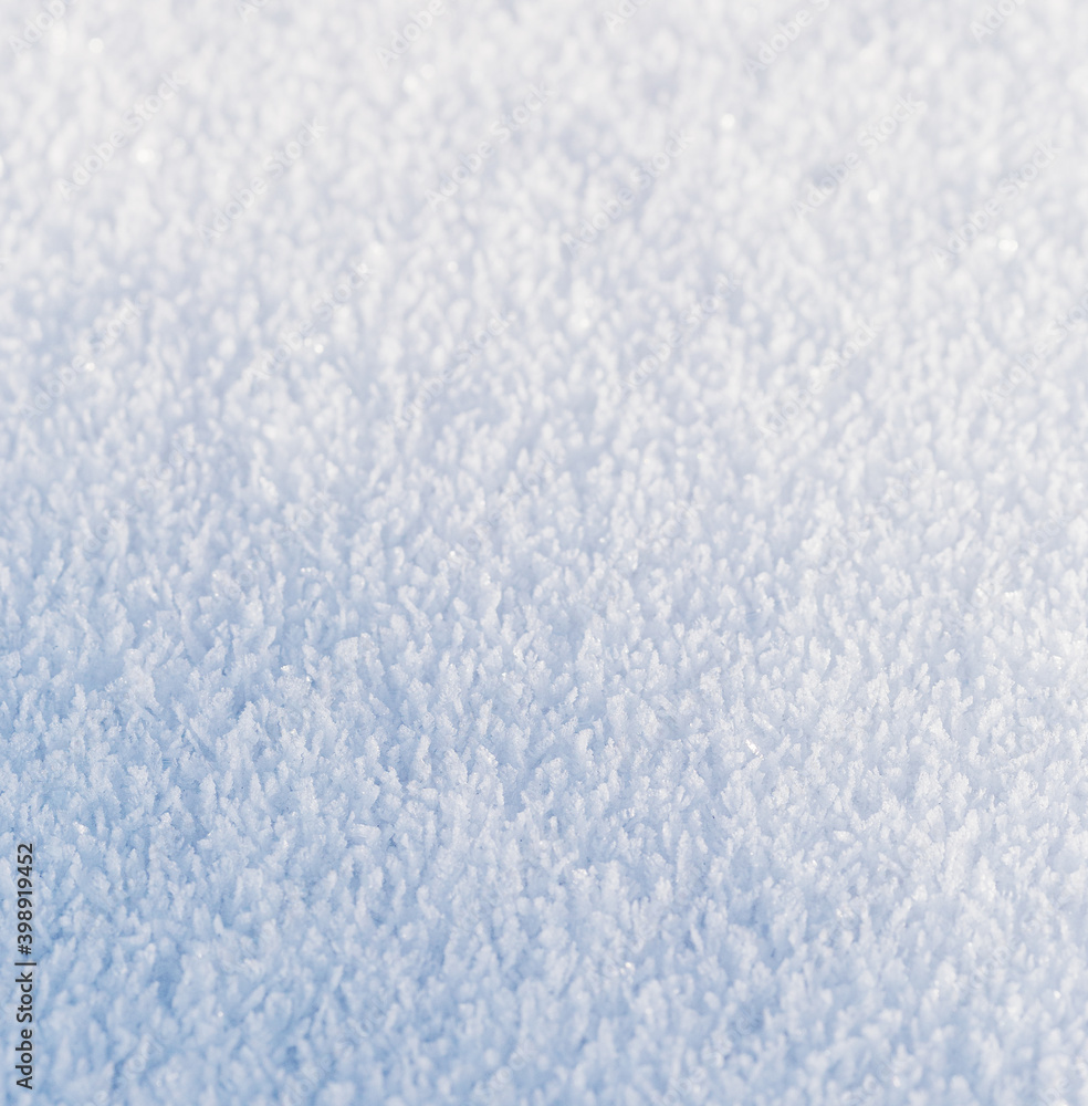 Snow, the texture of the surface of white snow with large crystals, illuminated by the oblique rays of the winter sun, background. Snow, the texture of the surface of white snow with large crystals, illuminated by the oblique rays of the winter sun, background.