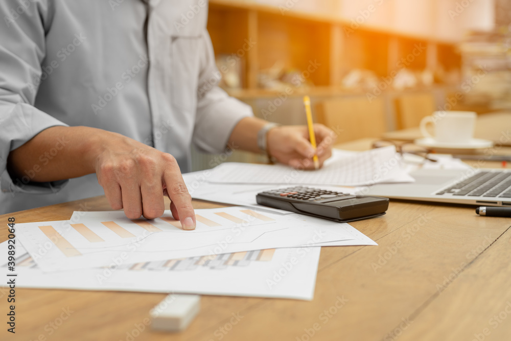Business hands pointing for checking report chart. Businessman analyzing financial report company and calculate profit with report summary. Business hands pointing for checking report chart. Businessman analyzing financial report company and calculate profit with report summary.