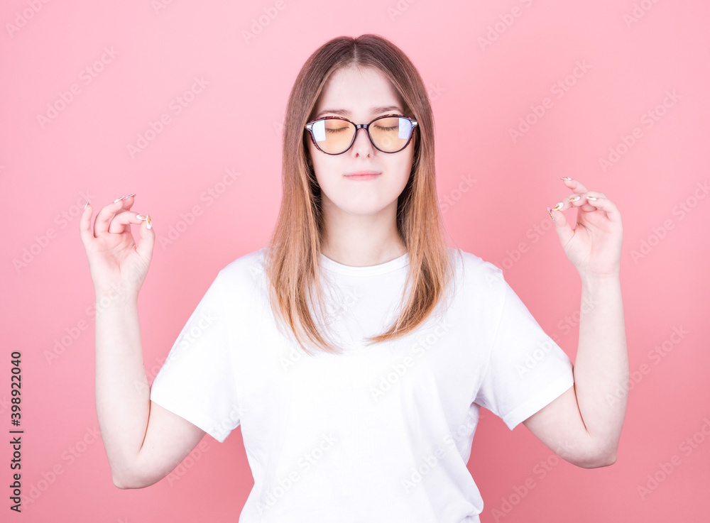 relaxed caucasian woman meditating in yoga pose isolated over pink background relaxed caucasian woman meditating in yoga pose isolated over pink background