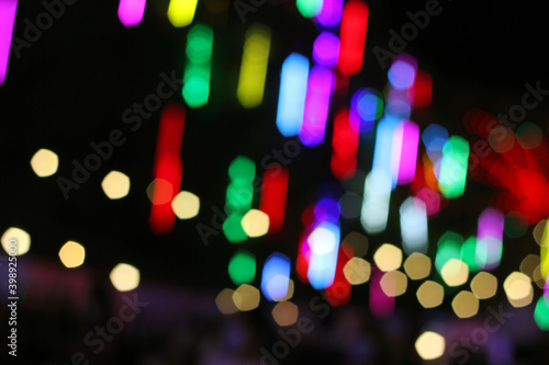 Blurred light from night festival in Chiangmai, Thailand. Blurry brake lights. Colorful bokeh background. Background for happy new year 2021.