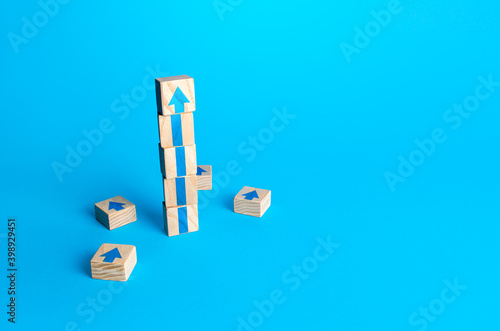 Block tower with arrows. Business growth and development concept. Achieve success. Building career advancement, improving skills. Goal achievement. Progress and movement forward. Self improvement photo