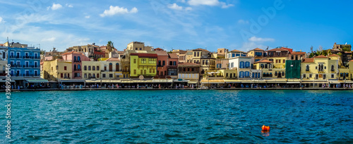 A panorama view of the mulit-coloured restaurants and bars in the harbour bay of Chania, Crete on a bright sunny day