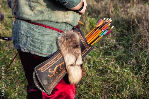 Ancient leather arrow quiver with archery ornament photo