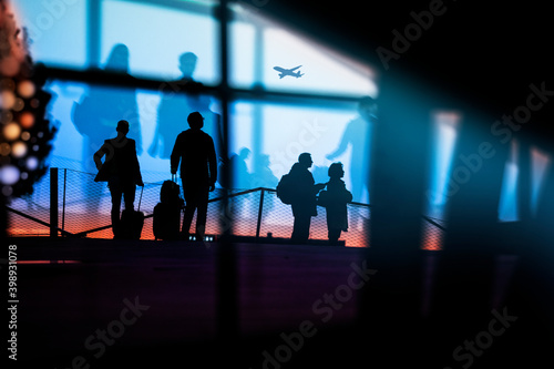 Silhouettes of people waiting in the airport for delayed or cancelled flights because of Corona virus, coming home for Christmas in 2020