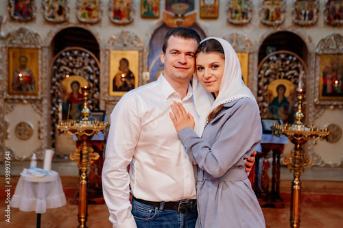 beautiful married couple in the church. Christian family religious traditions.  © andrey