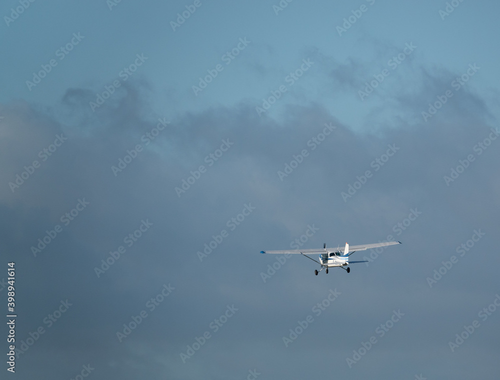 light aircraft heading off towards a blue cloudy sky light aircraft heading off towards a blue cloudy sky