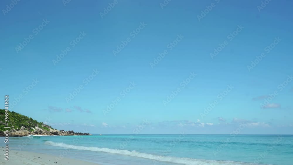 Exotic beach by the ocean with rolling waves on the sandy shore and blue sky. Timelaps Exotic beach by the ocean with rolling waves on the sandy shore and blue sky. Timelaps
