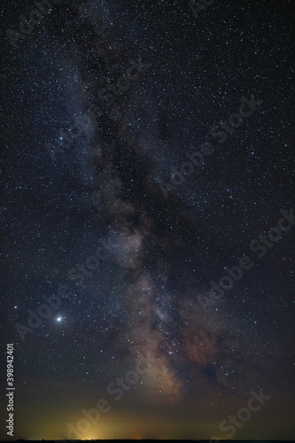 Stars in the sky at night. Bright Milky Way over the city.