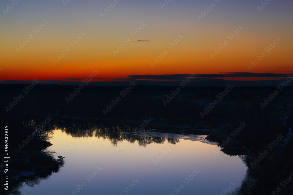 View of the river from the cliff. Evening sky after sunset.